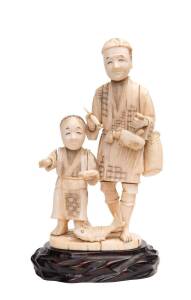 A Japanese Okimono carved ivory figure group on wooden base, Meiji period. 