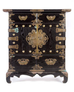 A good Korean four drawer, two door elm cabinet, Yi Dynasty, 19th Century with finely engraved gilt-copper & brass fittings, supported on a low stand. 118cm high, 107cm wide, 51cm deep. Provenance: From a collection acquired in Sydney between 1962 and 196