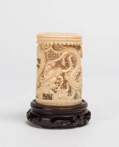 A Chinese carved ivory dragon vase on later wooden stand, early 20th Century.