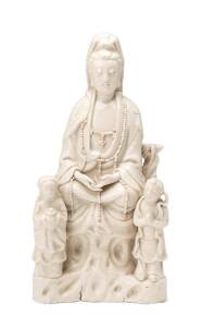 A Blanc-de-Chine seated Guanyin with two children, Kangxi period (1662-1722), 24cm height