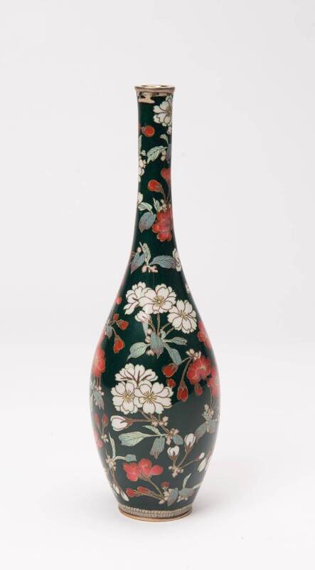 A Japanese cloisonné vase, Meiji period (1868-1912) with elongated neck, gold and silver wired decoration. Adorned with two-tones of Sakura cherry blossom, in bloom with multi-toned foliage. Applied on an opulent jade green ground. 24cm high
