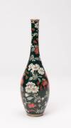 A Japanese cloisonné vase, Meiji period (1868-1912) with elongated neck, gold and silver wired decoration. Adorned with two-tones of Sakura cherry blossom, in bloom with multi-toned foliage. Applied on an opulent jade green ground. 24cm high