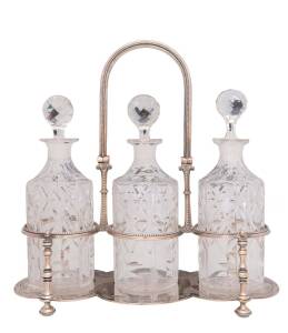 A silver plated tantalus with set of three matching crystal decanters, English 19th century. 33cm high