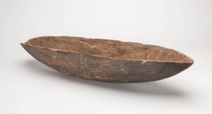 A fine & early coolamon, Northern Territory (circa 1900), carved wood & natural earth pigments. 65.7cm long.