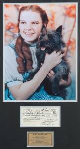 JUDY GARLAND, signature on cheque, window mounted with colour photograph of Judy in "The Wizard of Oz", framed & glazed, overall 52x81cm. With CoA.