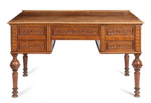 A French oak desk with carved drawer fronts resting on turned legs, 19th century