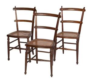 A set of four Australian caned cedar dining chairs & a matching cedar rocking chair, late 19th Century