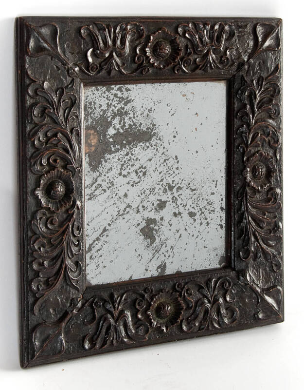 A provincial carved oak wall mirror, French, 18th Century. 43cm high, 40cm wide.