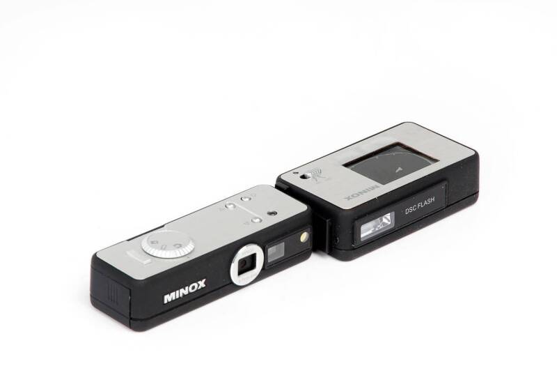 MINOX (Germany): A Minox group with Minox III  in red leather case, a Minon DSC (Digital Spy Camera), 2008, with DSC flash attachment in original Minox packaging, and  a small group of Minox accessories.