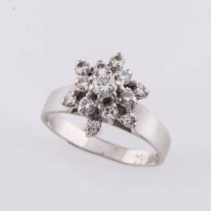 A diamond cluster ring, set with small round brilliant diamonds. 18ct white gold. Ring size K1/2. 