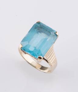 A blue topaz dress ring, the emerald cut topaz measuring 15mm x 11mm. 14ct yellow gold. Size L1/2