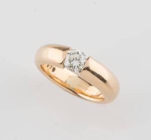 A solitaire diamond ring, the tension set round brilliant cut of approximate weight .70 carat. 18ct yellow gold. Weight 12.59 grams. Ring size O. Maker's mark Dy Kee. 