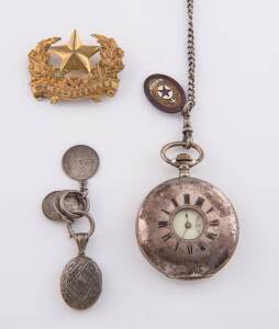 A half hunter pocketwatch and fob chain. Silver. To be sold with various medals, a locket and a badge.