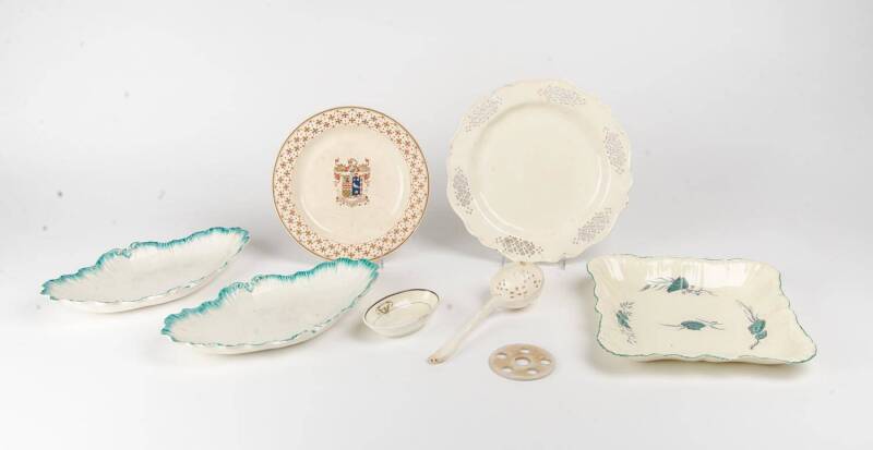 A collection of 18th century Wedgwood cream ware comprising a rectangular shell dish, an armorial plate, a pair of dishes, pierced plate, bud vase, ladle & oval dish