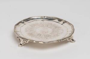 A Georgian sterling silver card tray, marks illegible. 17cm diameter 