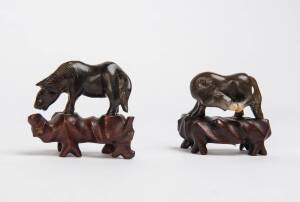A pair of dark jade horses with wooden stands, 20th Century. 4cm high