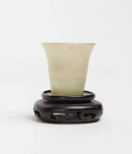 A small green jade cup with stand, 4cm high