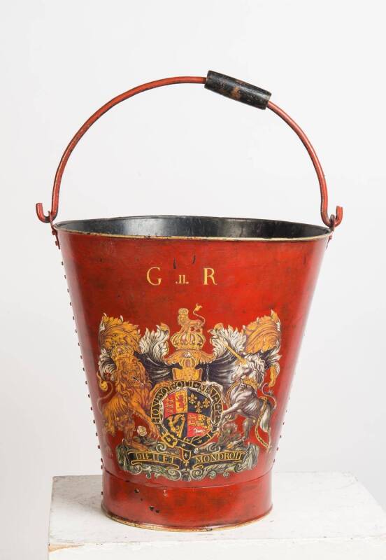 A large red painted tole ware coal bucket with central family cresting. 45cm high, 41cm diameter.