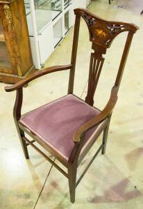 An Arts and Crafts style carved and inlaid elbow chair, first half 20th century