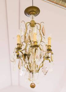 A crystal and metal six branch chandelier, early 20th century. 