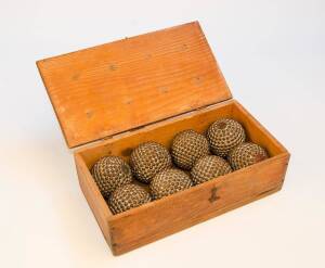 BOULES CLOUTEES: Set of 8 boxwood balls studded with nails, for boules (France) or Bocce (Italy), in wooden box, 19th Century.