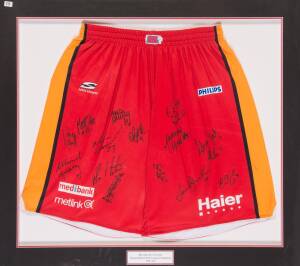 MELBOURNE TIGERS: Melbourne Tigers shorts signed by 2007-08 Championship team, with 15 signatures, window mounted, framed & glazed, overall 105x94cm.  [Proceeds to Kids Under Cover].