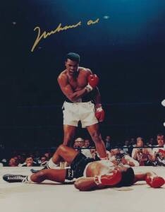 MUHAMMAD ALI, signed colour photograph of Ali standing over Sonny Liston, size 28x35cm. With CoA #0471.