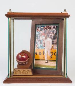 SHANE WARNE: Signed cricket ball, attractively mounted in display case with framed photograph. With CoA.