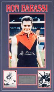 RON BARASSI: Nice signature on photograph wearing Melbourne jumper, window mounted with two action photographs; framed & glazed, overall 54x87cm. With CoA.