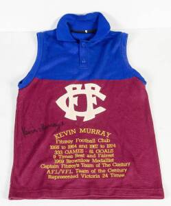 KEVIN MURRAY, nice signature on Fitzroy jumper, embroidered with details of his football career, good condition. Plus Bob Skilton display with signed photograph (signature faded) & replica Brownlow Medals; framed & glazed, overall 56x87cm.