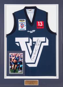 E.J.WHITTEN LEGENDS GAME: Victoria jumper worn by Doug Hawkins (on the bench) in the 2007 match, signed by Doug Hawkins on the front, window mounted, framed & glazed, overall 83x109cm.