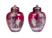 A pair of Mary Gregory cranberry glass vases & covers, decorated with a lady & her companion 24 cm high