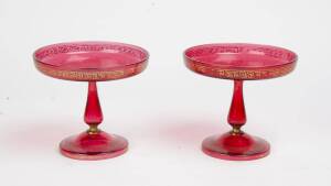 A pair of ruby glass comports with gilt decoration, 19th Century. 16cm high.