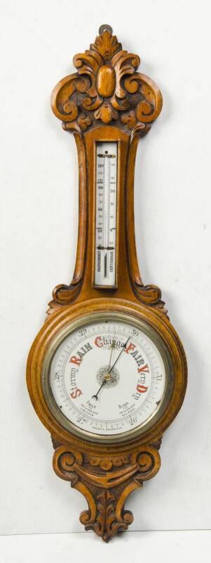 An English aneroid banjo barometer in oak case. 80cm.