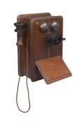 An oak case early wall mount telephone with slope front. 42cm high.