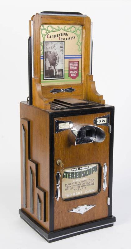 An ebonized chrome mounted oak cased penny arcade stereoscope, circa 1920s together with a collection of stereoscope viewer cards of nudes etc (separate power cable). 94cm high, 33cm wide, 30cm deep