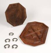 Two Nigerian carved awkawood trays and a collection of 5 bronze rings, 20th century, the largest tray 48cm wide x 31cm deep.