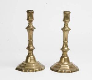 A pair of brass candle sticks, 18th Century. 27cm. 