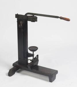 An Italian pine and cast iron bottle corking machine stamped “Marca di Fabrica Depositeata”. 