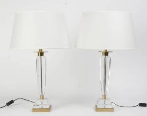 A pair of faceted glass and brass lamps, with white shades, 20th Century. 72cm high