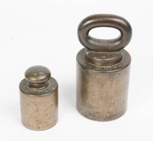 Two Victorian brass Troy weights, 19th Century, each marked ER VIC. probably used on the Victorian Goldfield's. comprising of 300oz weight & 100oz weight. The largest 21cm high. 