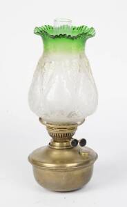 A kerosene lamp, double black button burner on brass front with shade and flue, late 19th/early 20th Century. 39cm. 