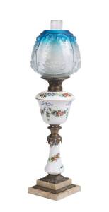 An antique oil lamp with hand painted floral porcelain font and column with blue glass shade (electrified). 67cm. 