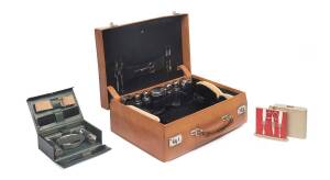 An Edwardian gentleman's travelling leather vanity case together with two leather cased vanity sets. 15cm high, 45cm wide, 30cm deep