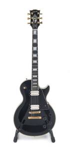 GIBSON LES PAUL Custom 1988 electric guitar, manufactured in Nashville U.S.A. with original hard case. One piece mahogany neck with ebony fingerboard and block mother of pearl inlays. Mahogany body with carved maple top in an Ebony finish. Pickups replace