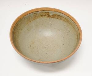 A large stoneware bowl with celadon and black glaze, 20th Century. 10cm high and 23.5cm diameter