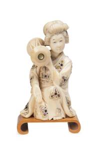 Ivory carving of Japanese lady in traditional costume inlaid with mother of pearl. Taiko (drum) on right shoulder. Signed Yoshisada on inlaid coral tablet.