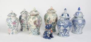 Three pairs of Chinese lidded vases, one pair decorated with peacocks (45cm high), one floral pair (3cm high), a blue & white pair (46cm high), and a porcelain dog (25cm high)