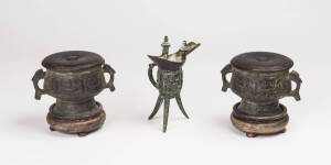 A group of three archaic style bronze vessels including a pair of bronze vessel "Gui" and a bronze vessel "Jue", 20th Century. Jue 15cm high, Gui 8.5 x 5.5cm