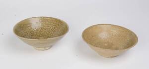 Two large molded celadon bowls, circa 14th Century. 21.5cm and 20.5cm diameter